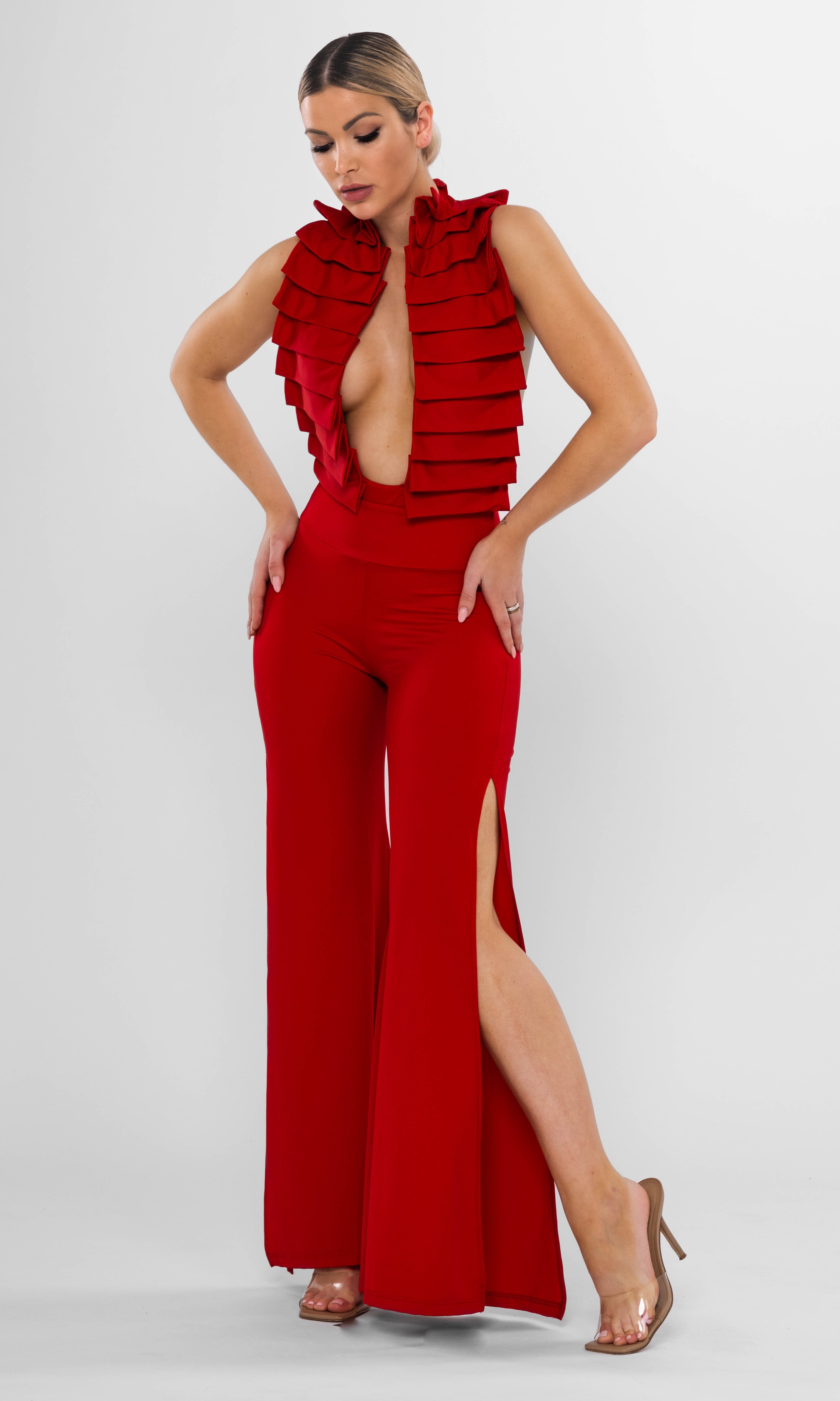 Luxury sustainable red Cleo pants by Antoninias, designed with a high-waisted fit, dramatic front slits, and a flowing silhouette, perfect for premium resort wear and designer womenswear.