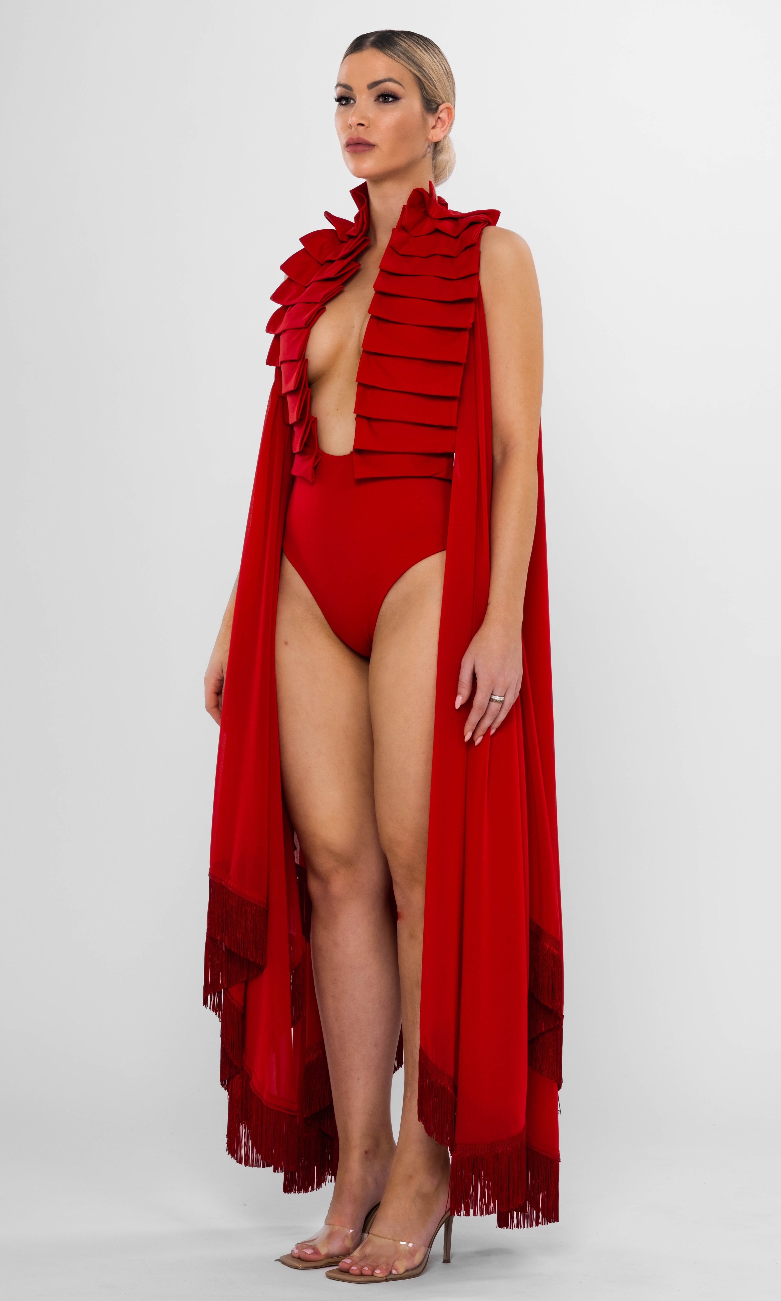Luxury sustainable Resetius cover-up in red by Antoninias, designed with flowing silhouette, layered fringe hem, and gold-tone belt, perfect for premium resort wear and sophisticated womenswear.